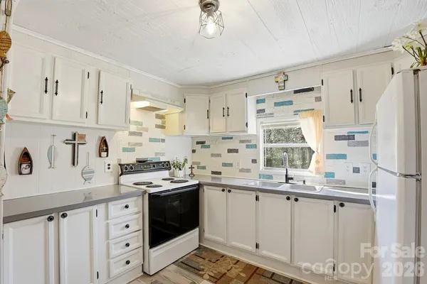 a kitchen with a sink stove and cabinets