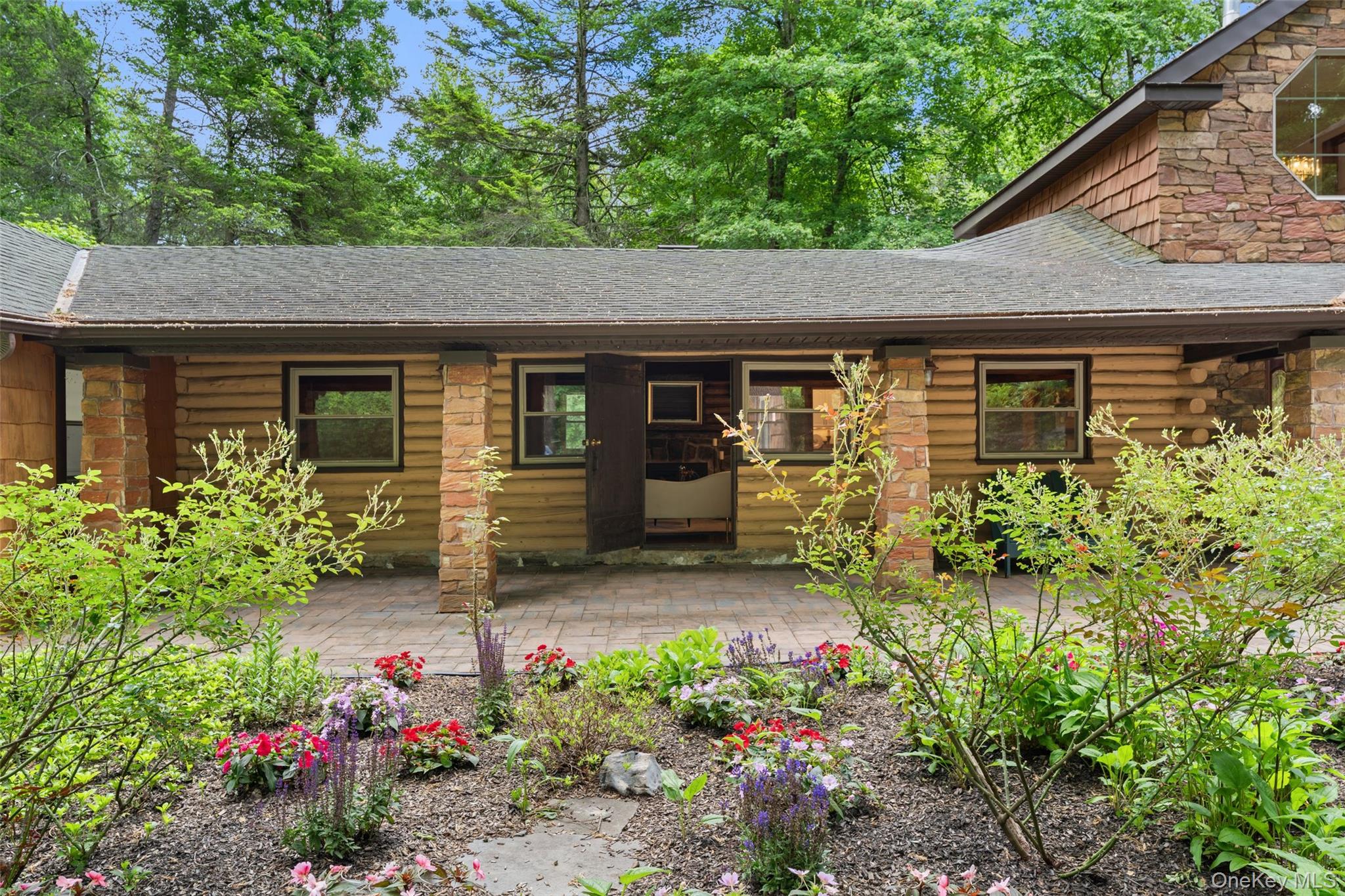 25 Cabin Ridge Road Chappaqua, NY 10514 - Photo 2 of 39 Exterior featuring wood siding, stone accents, and a covered patio
