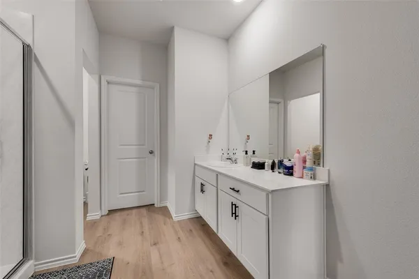 a bathroom with a double vanity sink mirror and