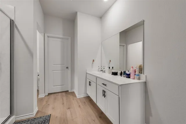 a bathroom with a double vanity sink mirror and