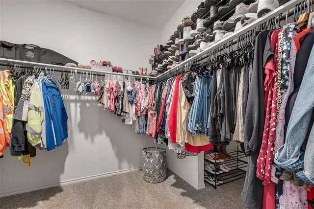a view of walk in closet with clothes