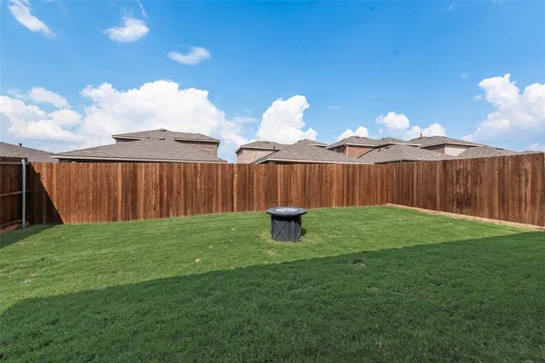 a view of a backyard with table and chairs