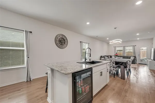 a kitchen with a table chairs stove and wooden floor