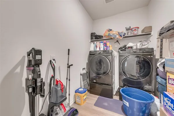a view of a storage and utility room with washer and dryer