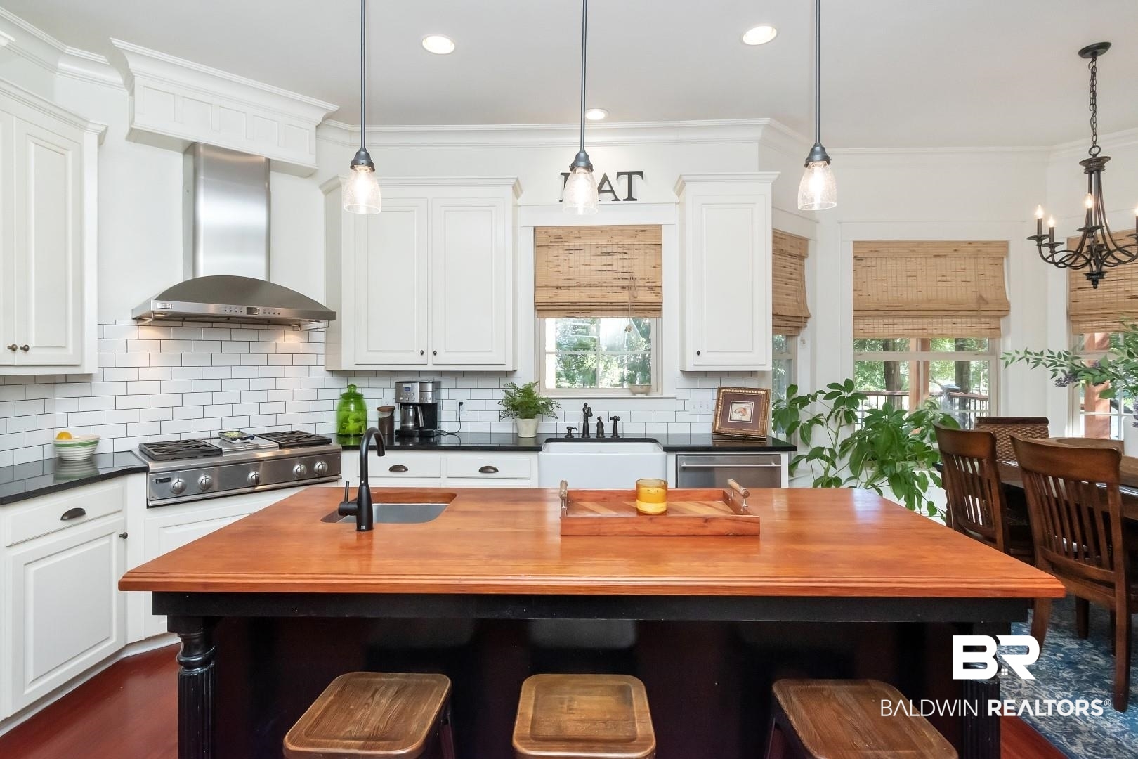 8868 Dawes Lake Road South Mobile, AL 36619 - Photo 11 of 35 Kitchen featuring appliances with stainless steel finishes, wall chimney exhaust hood, a healthy amount of sunlight, and a center island with sink