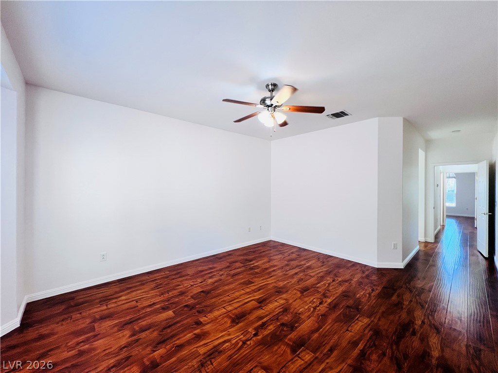 3047 Hickory Valley Road Henderson, NV 89052 - Photo 14 of 33 Rich hardwood flooring complements clean white walls in this spacious room, ready for your personal touch.