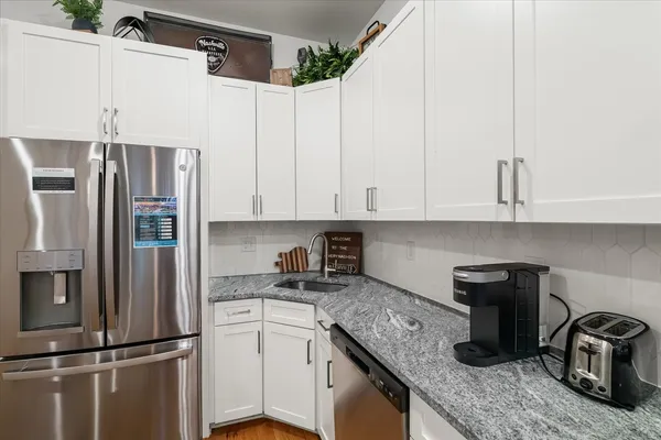 a kitchen with sink stove and cabinets