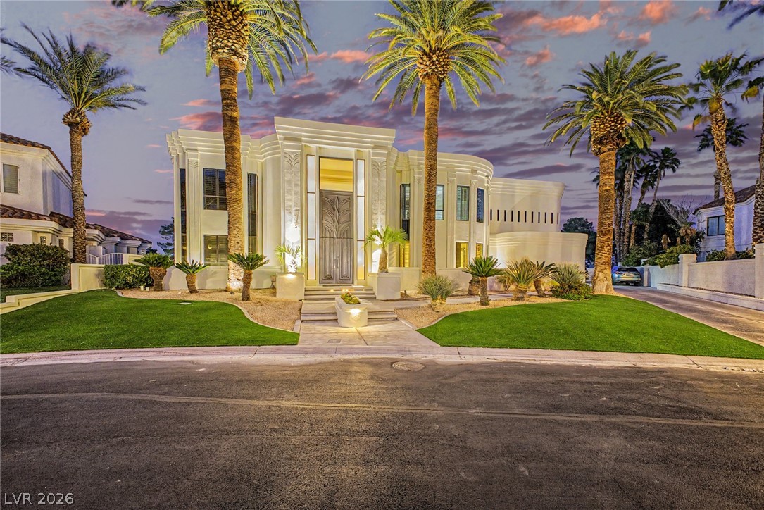 46 Gulf Stream Court Las Vegas, NV 89113 - Photo 1 of 62 This striking residence features clean lines and a grand entrance, complemented by lush landscaping and majestic palm trees.