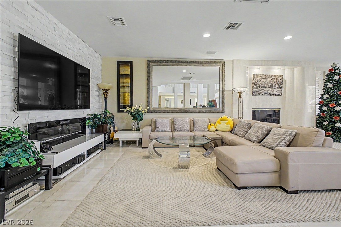 46 Gulf Stream Court Las Vegas, NV 89113 - Photo 10 of 62 This inviting living space features an elegant fireplace, perfect for cozy gatherings and stylish relaxation.