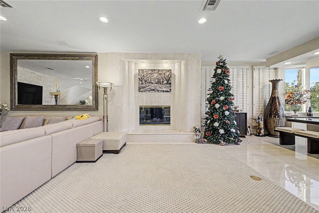 46 Gulf Stream Court Las Vegas, NV 89113 - Photo 11 of 62 This living area features recessed lighting, a statement fireplace, and ample natural light.