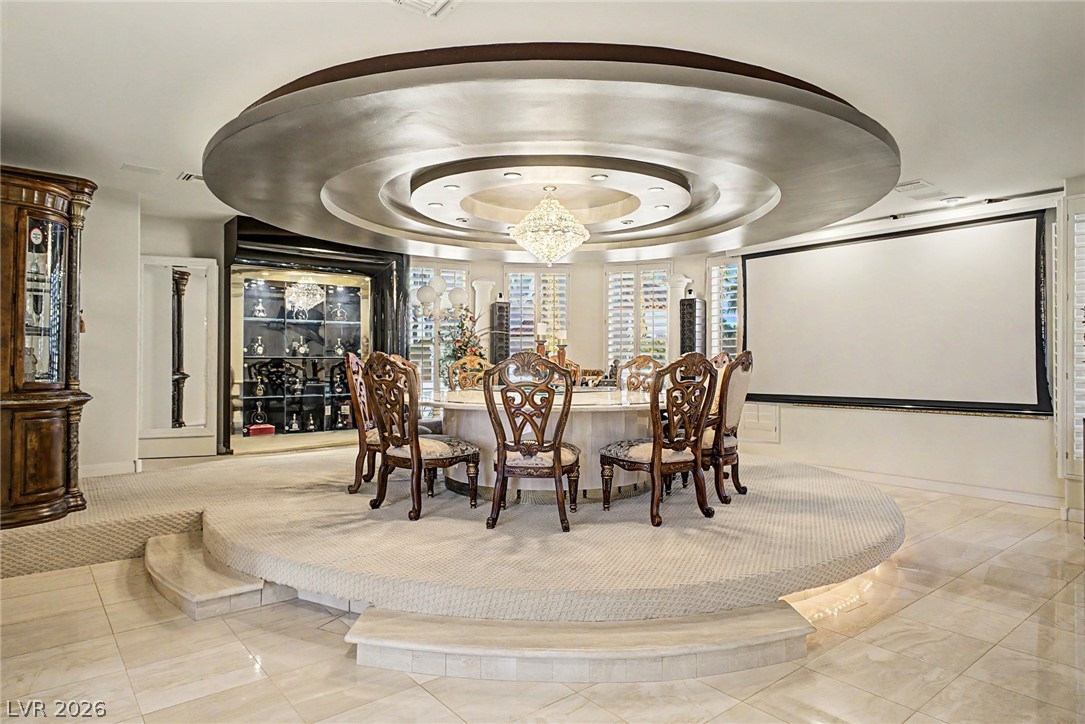46 Gulf Stream Court Las Vegas, NV 89113 - Photo 13 of 62 This elegant dining area boasts a unique raised platform and a dazzling chandelier, perfect for entertaining.