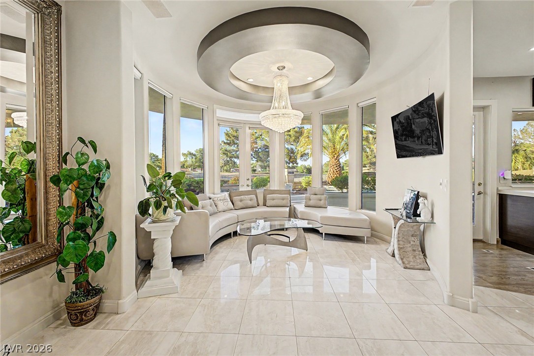 46 Gulf Stream Court Las Vegas, NV 89113 - Photo 16 of 62 This living room features expansive windows, glossy tile flooring, and a decorative ceiling.