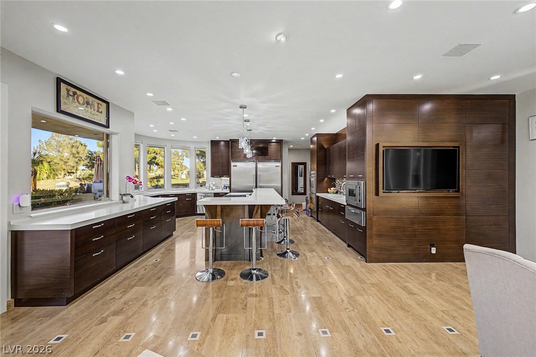 46 Gulf Stream Court Las Vegas, NV 89113 - Photo 19 of 62 This expansive kitchen features modern appliances, a large island, and ample counter space, perfect for culinary enthusiasts.