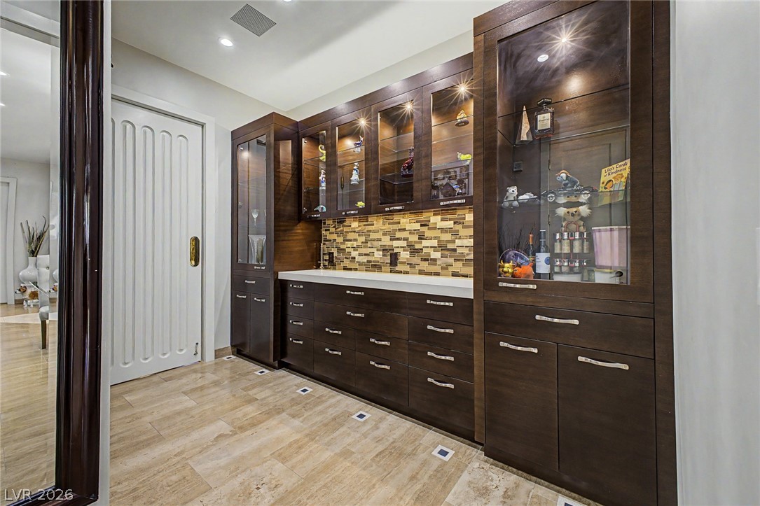 46 Gulf Stream Court Las Vegas, NV 89113 - Photo 22 of 62 This bar area features custom cabinetry, ample counter space, and integrated lighting, perfect for entertaining.