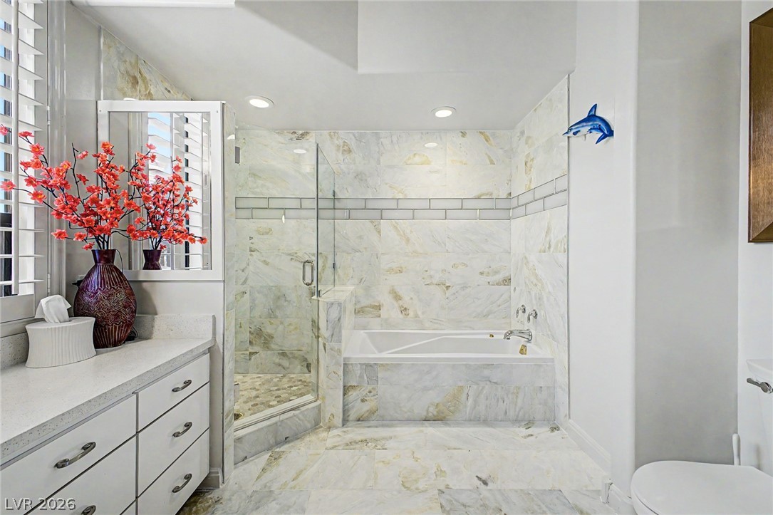 46 Gulf Stream Court Las Vegas, NV 89113 - Photo 27 of 62 Elegant primary bathroom featuring a spacious shower, soaking tub, and ample counter space.