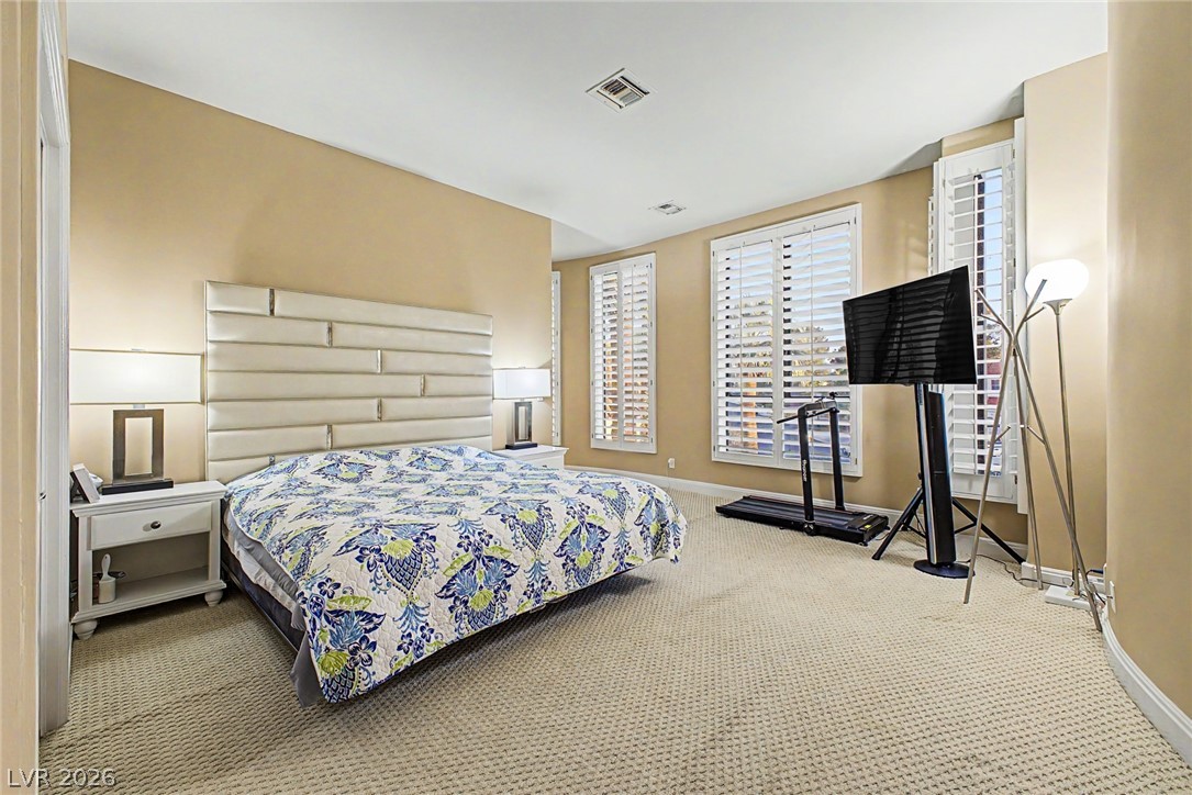 46 Gulf Stream Court Las Vegas, NV 89113 - Photo 29 of 62 This spacious primary bedroom features soft carpeting, recessed lighting, and ample natural light from multiple windows.