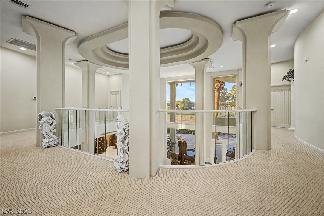 46 Gulf Stream Court Las Vegas, NV 89113 - Photo 32 of 62 This grand hallway features soaring ceilings, a unique architectural design, and panoramic views of the outdoors.
