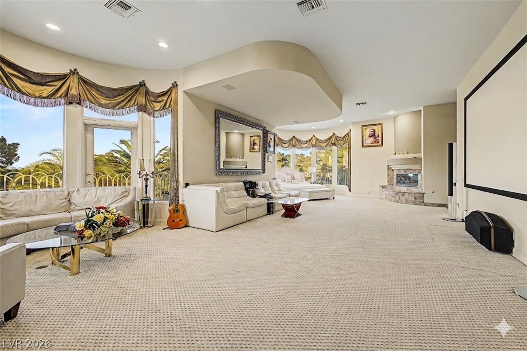 46 Gulf Stream Court Las Vegas, NV 89113 - Photo 33 of 62 This spacious living area offers abundant natural light and an elegant fireplace for comfortable gatherings.