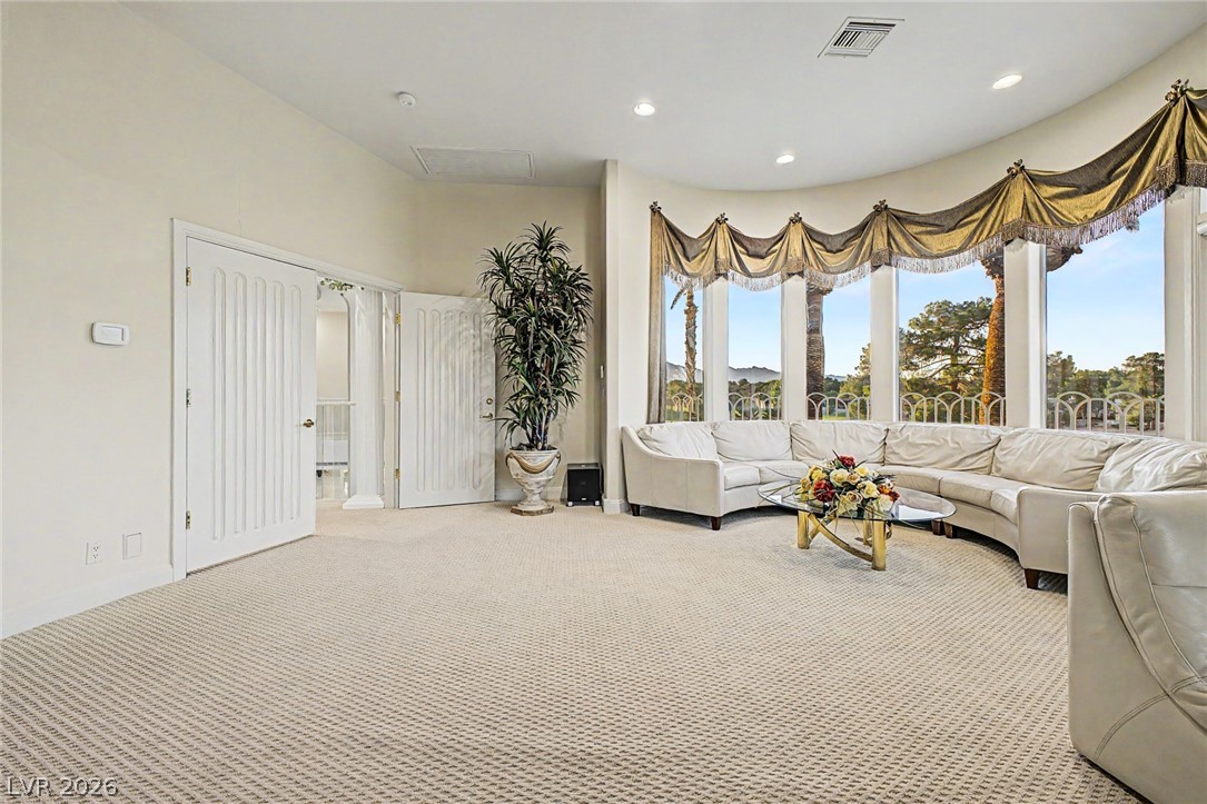 46 Gulf Stream Court Las Vegas, NV 89113 - Photo 35 of 62 This living room features a spacious layout with expansive windows and comfortable seating.
