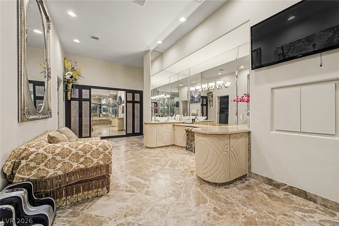 46 Gulf Stream Court Las Vegas, NV 89113 - Photo 39 of 62 This spacious primary bathroom offers a unique vanity design, perfect for daily routines.