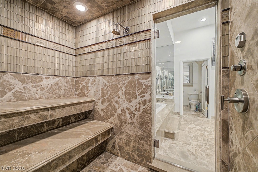 46 Gulf Stream Court Las Vegas, NV 89113 - Photo 44 of 62 This spacious shower features exquisite marble and tile work, creating a luxurious bathing experience.
