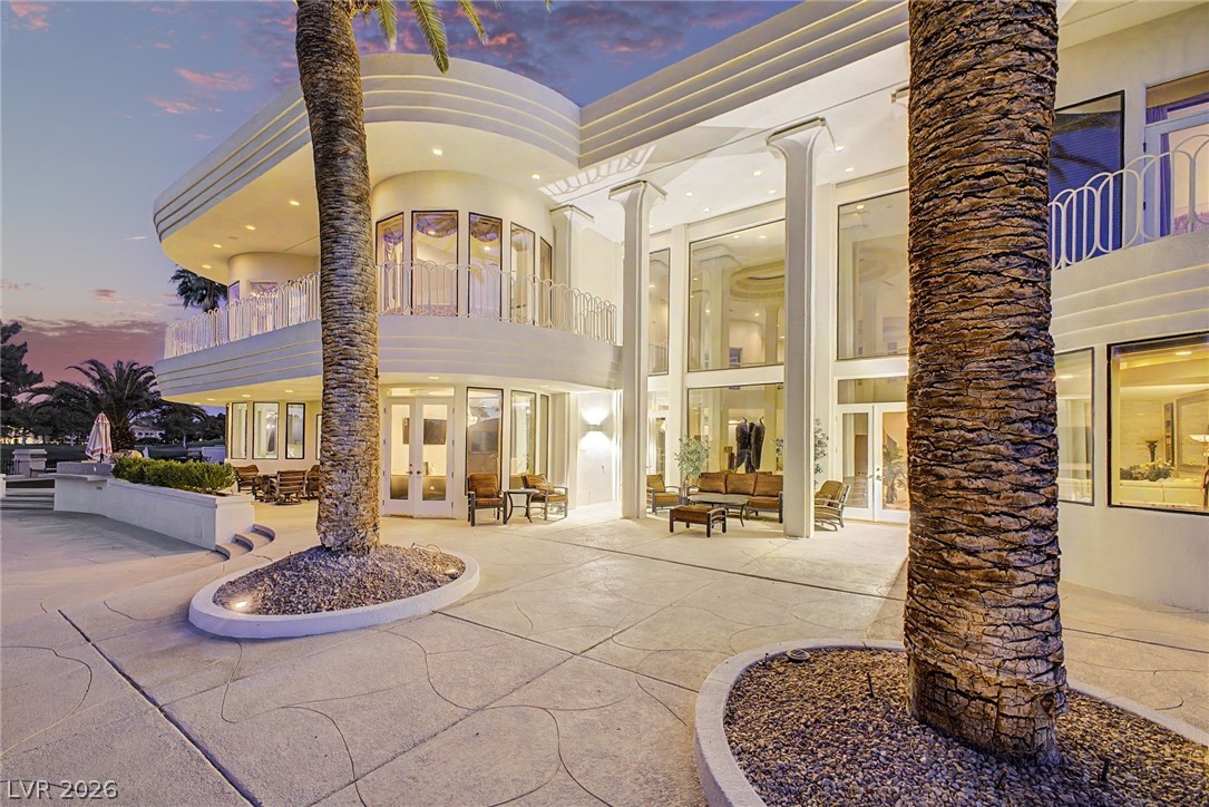 46 Gulf Stream Court Las Vegas, NV 89113 - Photo 47 of 62 This striking property features grand pillars and expansive glass, showcasing elegant outdoor living spaces.