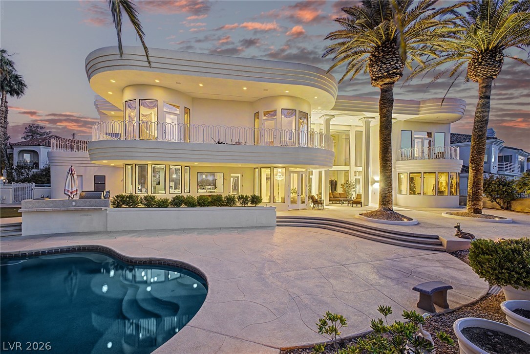 46 Gulf Stream Court Las Vegas, NV 89113 - Photo 48 of 62 An impressive multi-story residence with elegant curves, an inviting pool, and a grand outdoor patio.