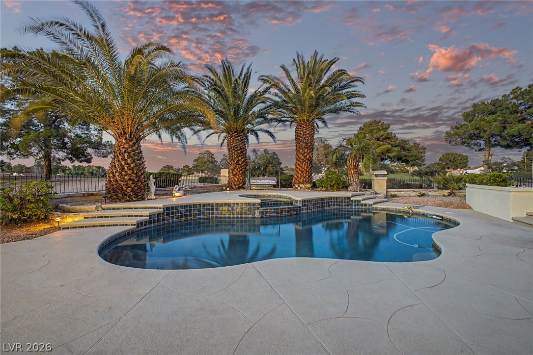 46 Gulf Stream Court Las Vegas, NV 89113 - Photo 49 of 62 This private outdoor oasis features a refreshing pool, surrounded by lush landscaping and majestic palm trees.