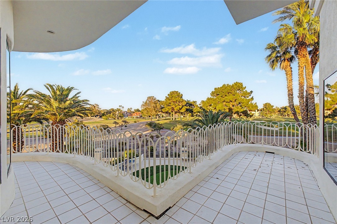 46 Gulf Stream Court Las Vegas, NV 89113 - Photo 54 of 62 This spacious balcony offers expansive views of a lush golf course, perfect for outdoor relaxation.