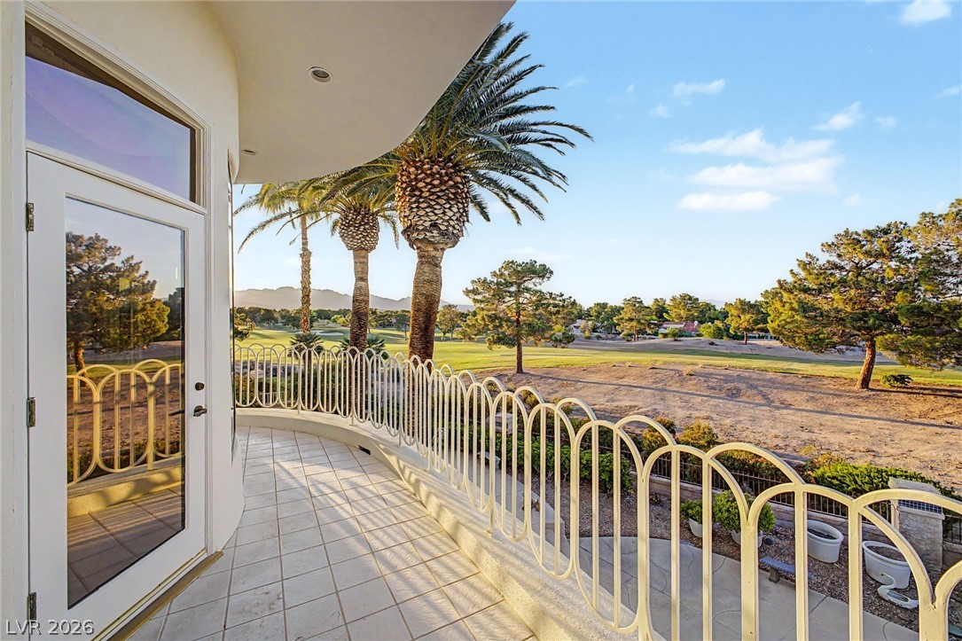 46 Gulf Stream Court Las Vegas, NV 89113 - Photo 56 of 62 This outdoor patio offers expansive views of a golf course and distant mountains, ideal for relaxation.