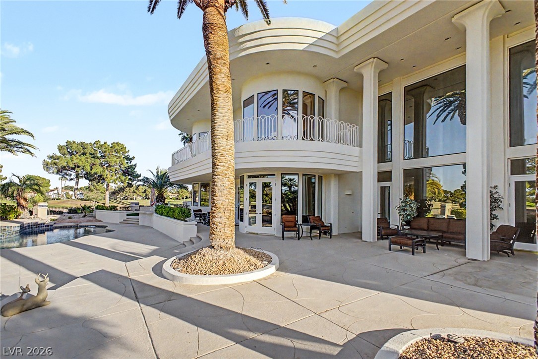 46 Gulf Stream Court Las Vegas, NV 89113 - Photo 58 of 62 This modern residence boasts a multi-level design with expansive windows, an outdoor patio, and a luxurious pool area.