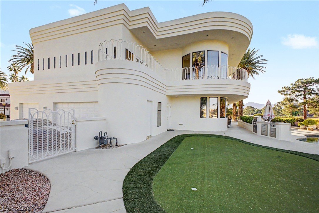 46 Gulf Stream Court Las Vegas, NV 89113 - Photo 59 of 62 This modern home features an outdoor putting green and kitchen, perfect for entertaining.