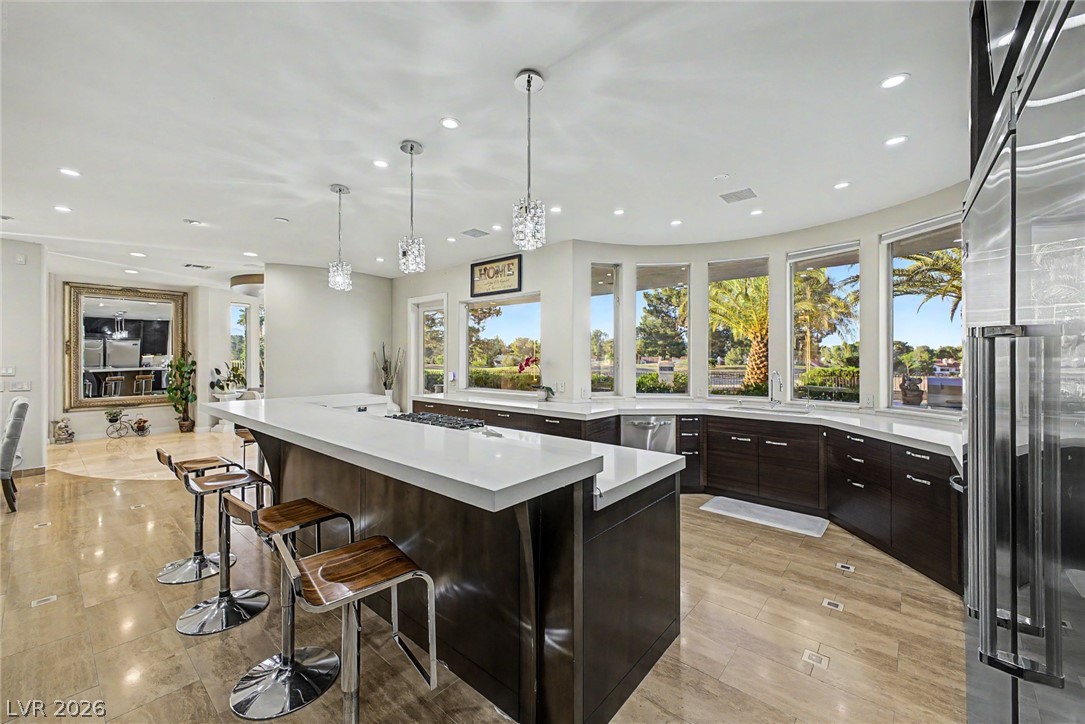 46 Gulf Stream Court Las Vegas, NV 89113 - Photo 6 of 62 This kitchen offers panoramic outdoor views, an expansive island, and integrated appliances.
