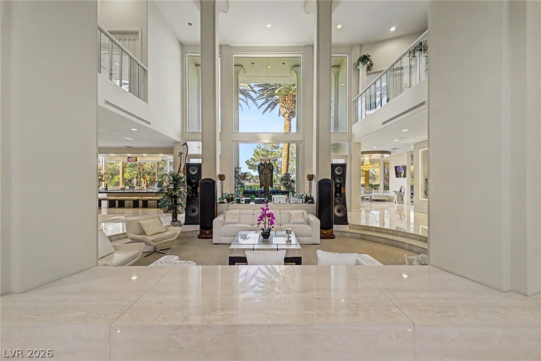 46 Gulf Stream Court Las Vegas, NV 89113 - Photo 62 of 62 This living room features expansive windows, high ceilings, and an open floorplan, creating a bright and airy atmosphere.