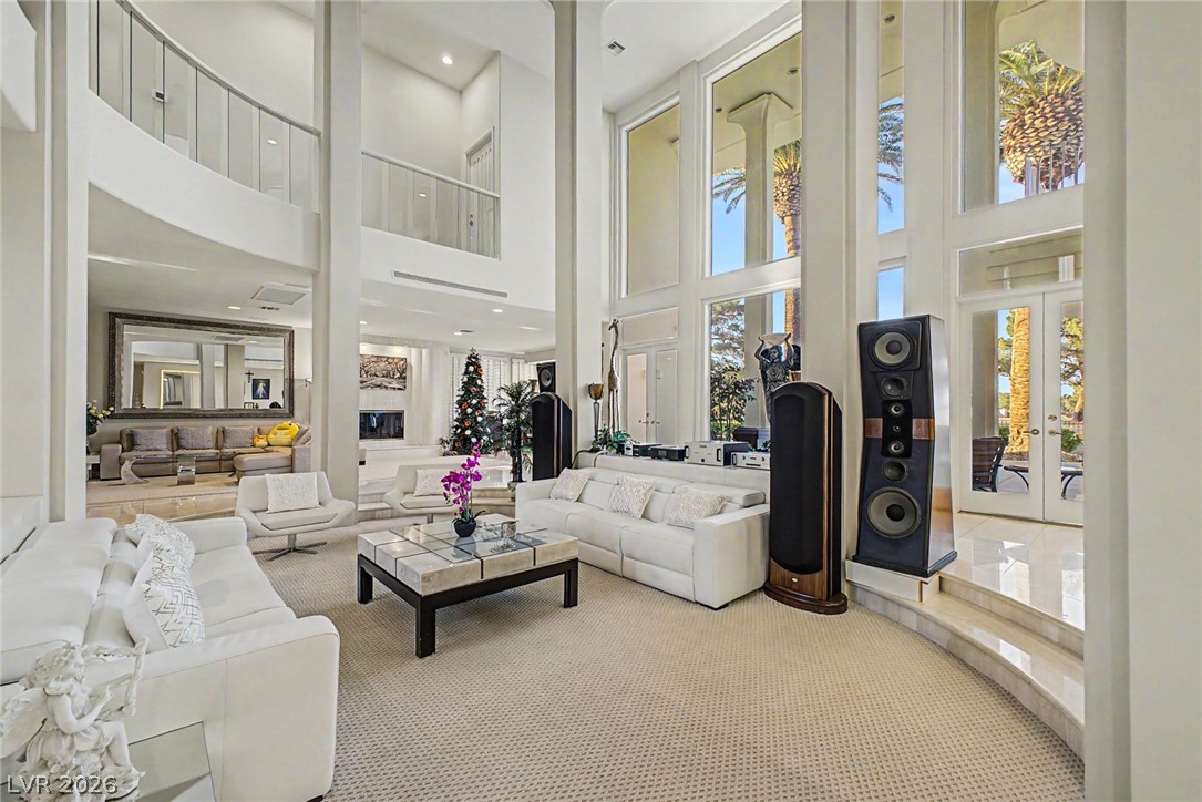 46 Gulf Stream Court Las Vegas, NV 89113 - Photo 7 of 62 This grand living area features high ceilings, ample natural light, and elegant interior architectural details.