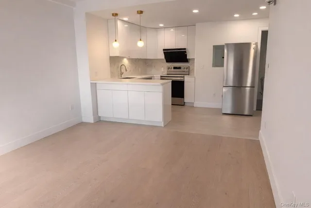 a view of kitchen with stainless steel appliances kitchen island a refrigerator sink and cabinets