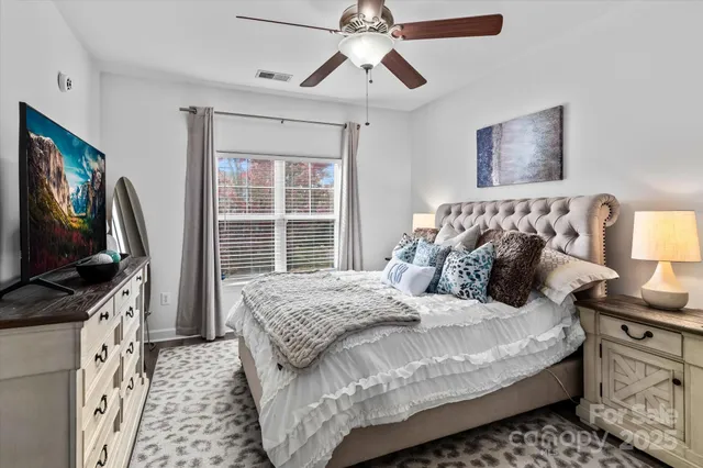 a bedroom with bed and flat screen tv