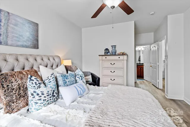 a bedroom with a bed and a chandelier