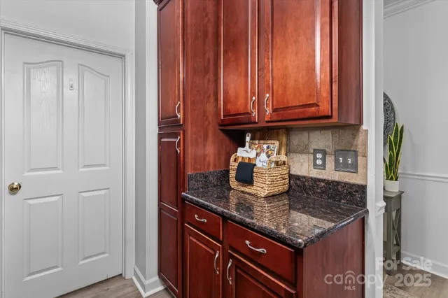 a kitchen with granite countertop a sink and cabinets