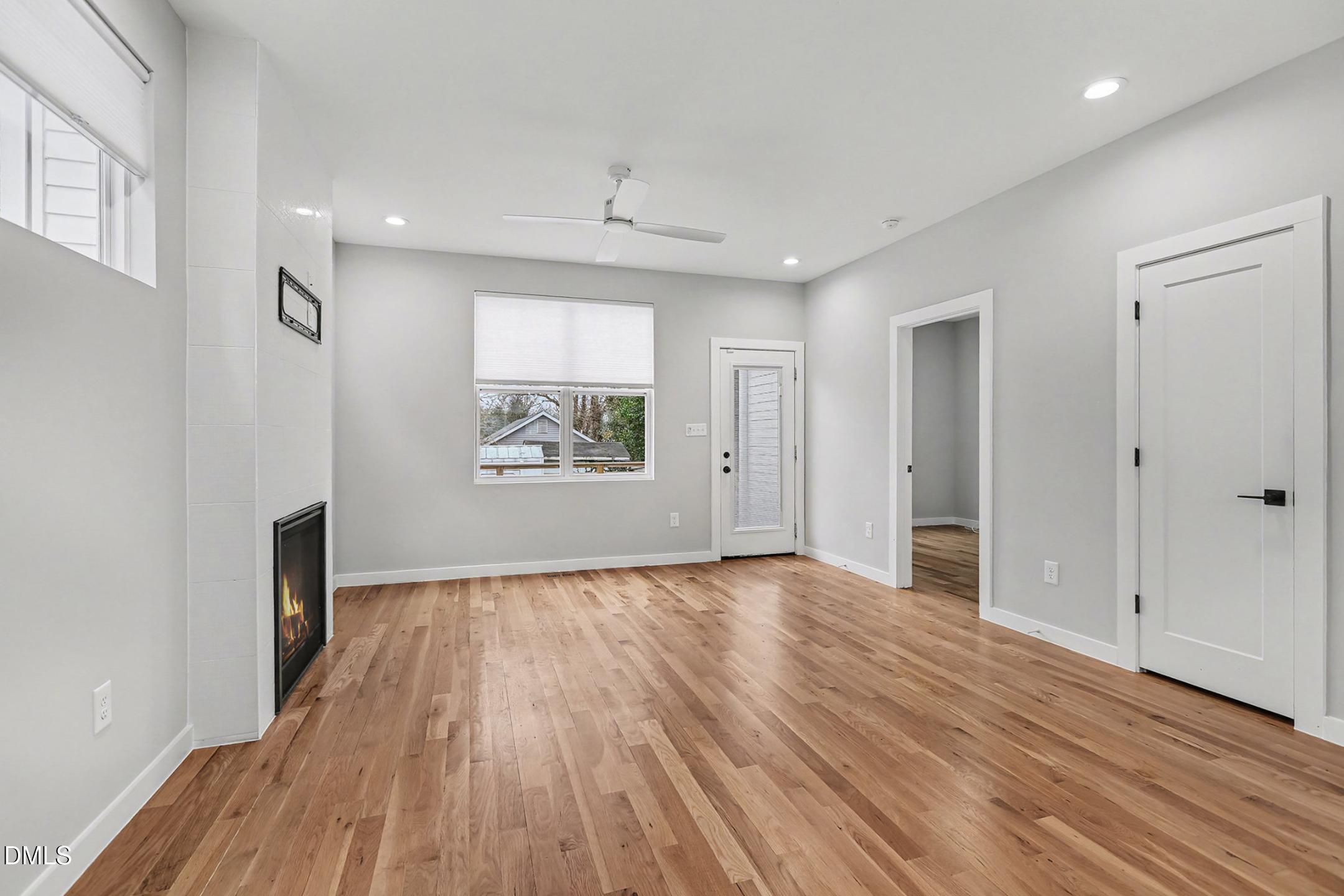 1508 East Jones Street Raleigh, NC 27610 - Photo 10 of 38 an empty room with wooden floor and windows