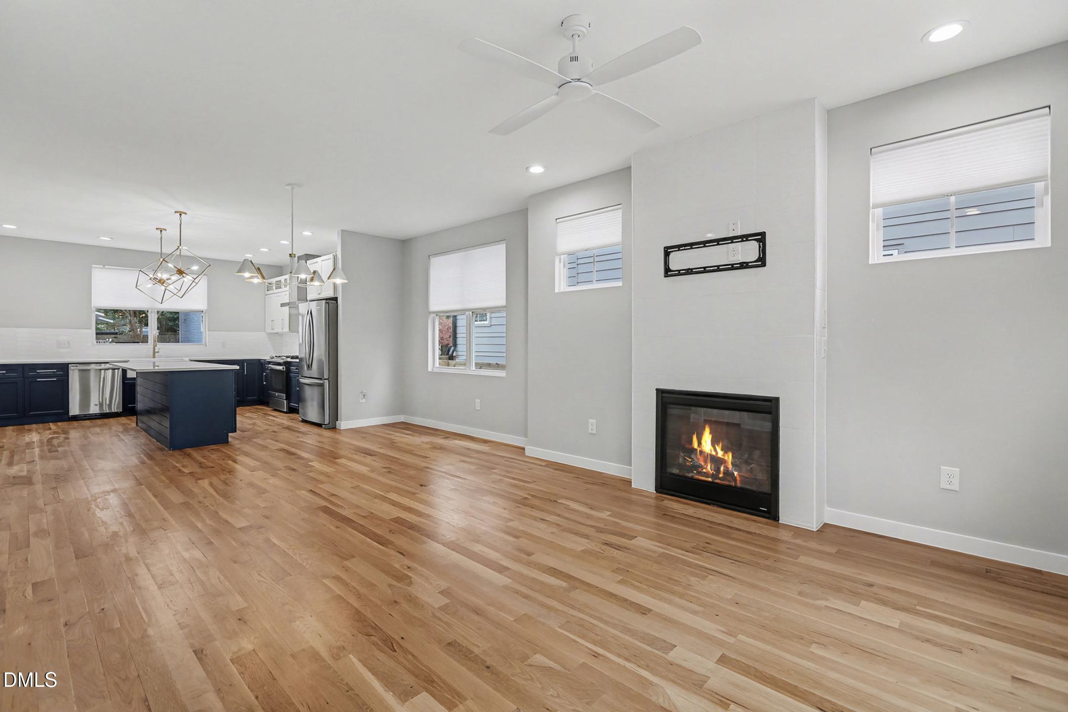 1508 East Jones Street Raleigh, NC 27610 - Photo 11 of 38 a view of empty room with a fireplace and wooden floor