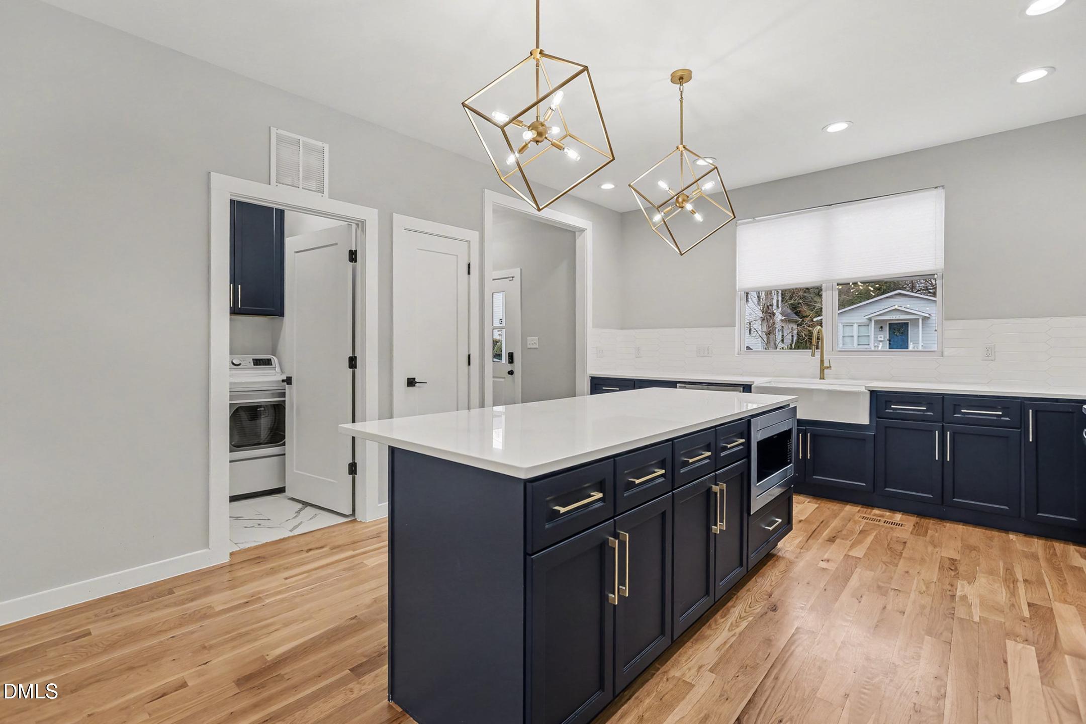1508 East Jones Street Raleigh, NC 27610 - Photo 14 of 38 a kitchen with stainless steel appliances granite countertop a sink and a stove top oven