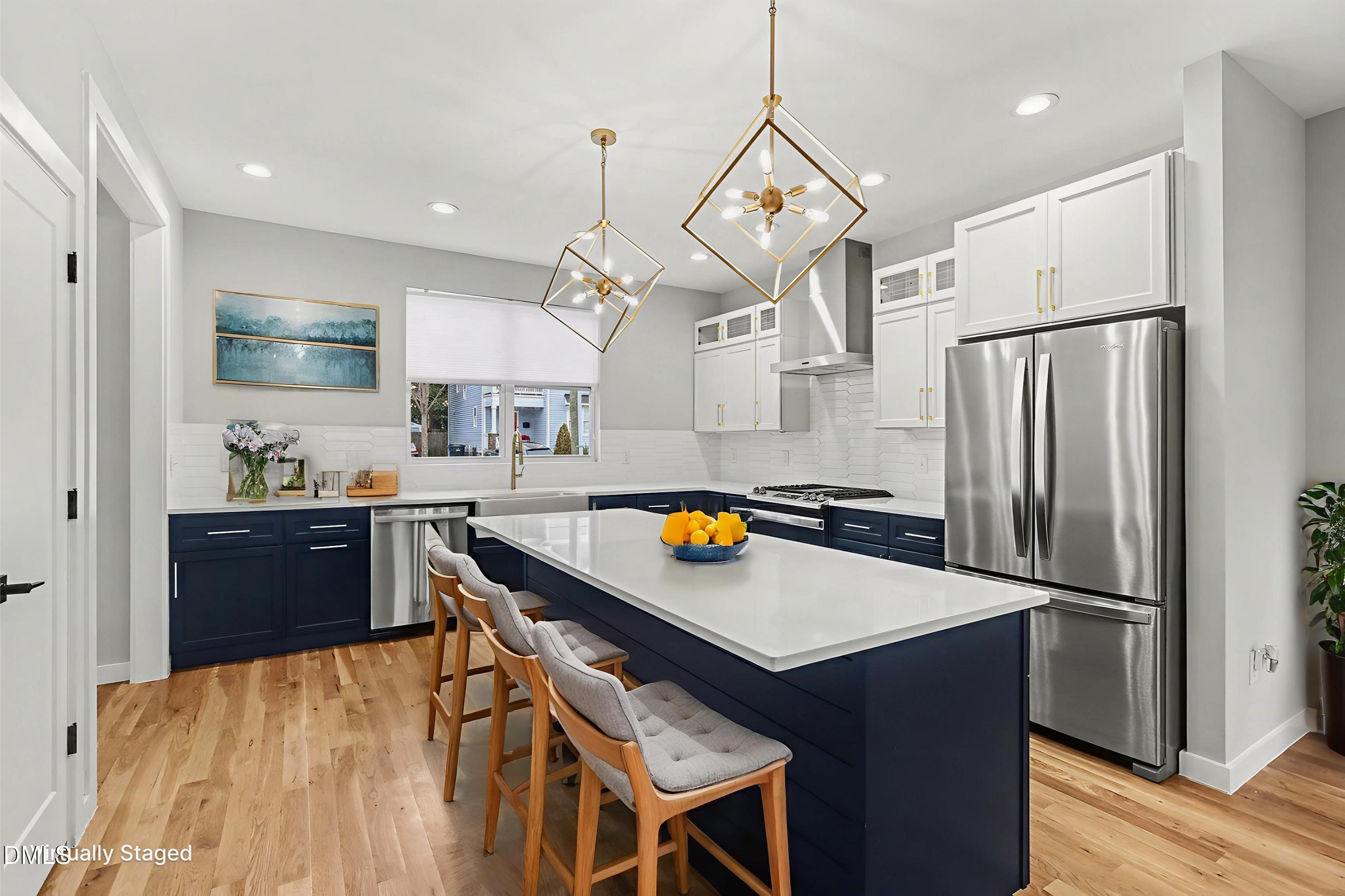 1508 East Jones Street Raleigh, NC 27610 - Photo 15 of 38 a kitchen with stainless steel appliances a refrigerator a sink dishwasher a stove and a dining table with wooden floor