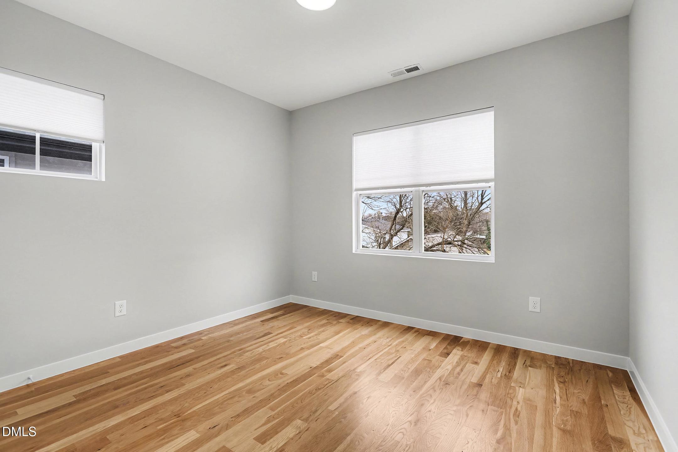 1508 East Jones Street Raleigh, NC 27610 - Photo 24 of 38 a view of an empty room with wooden floor and a window