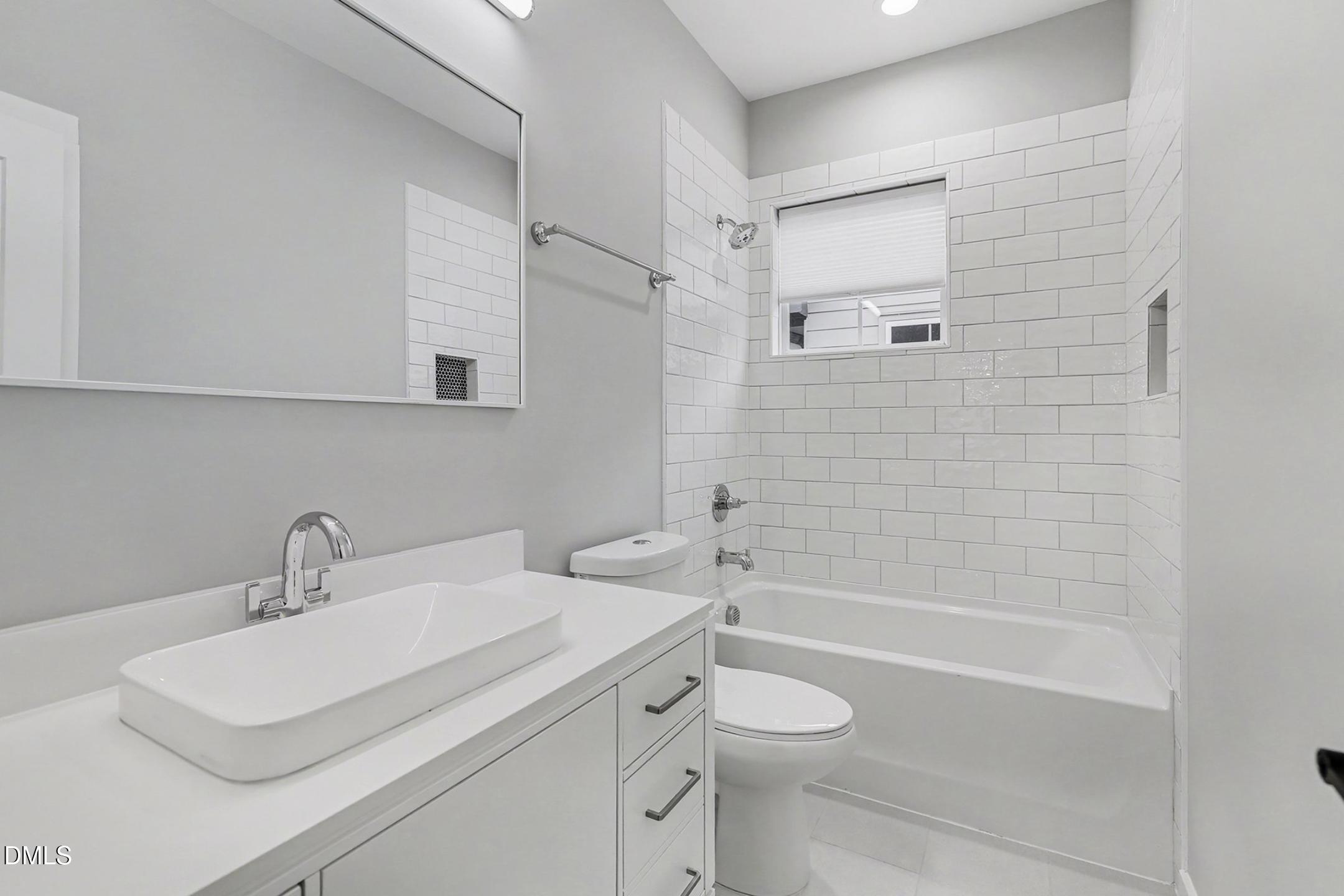 1508 East Jones Street Raleigh, NC 27610 - Photo 25 of 38 a bathroom with a sink a toilet and shower
