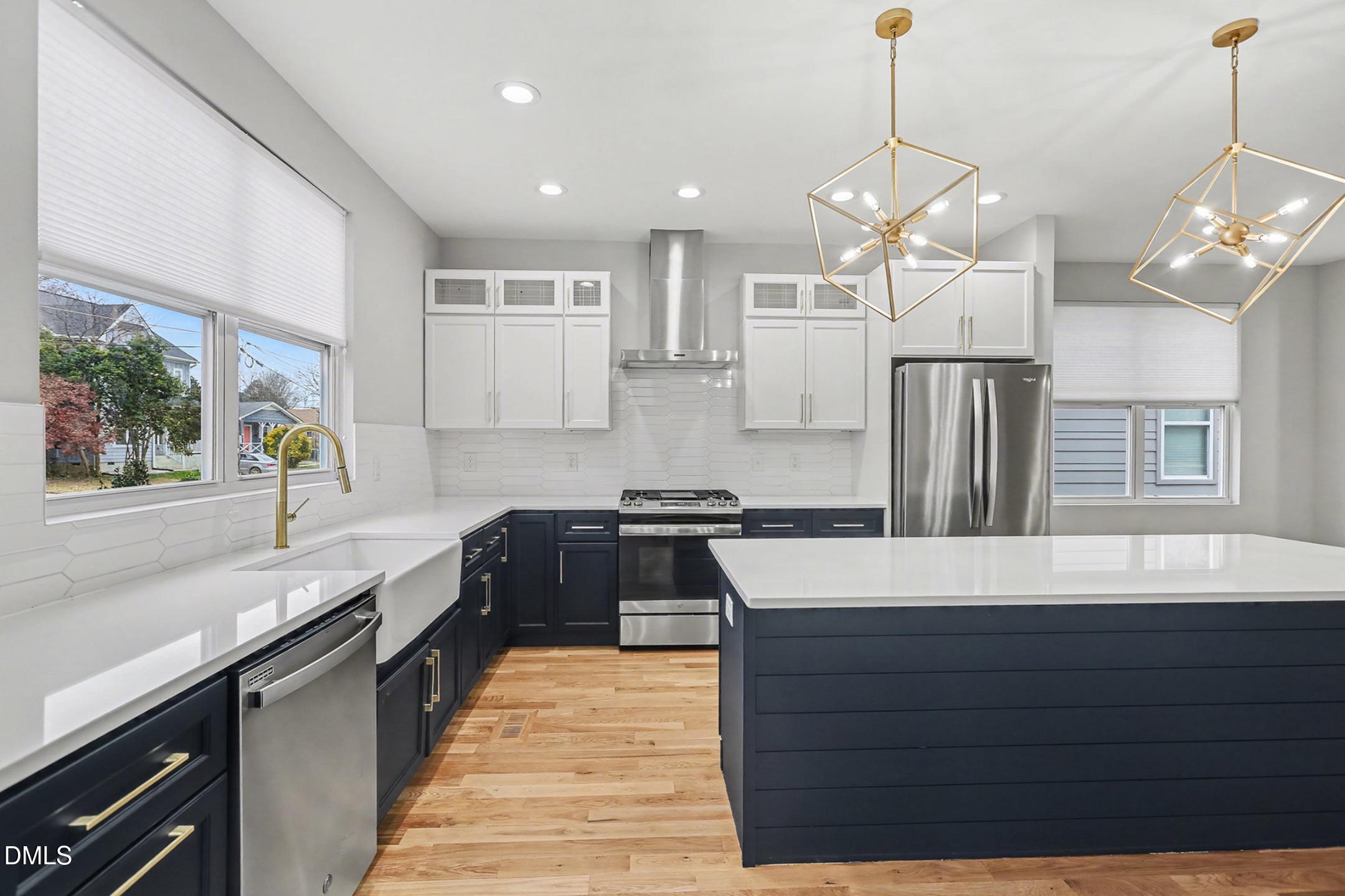 1508 East Jones Street Raleigh, NC 27610 - Photo 2 of 38 a kitchen with stainless steel appliances granite countertop wooden cabinets a stove a sink and a refrigerator