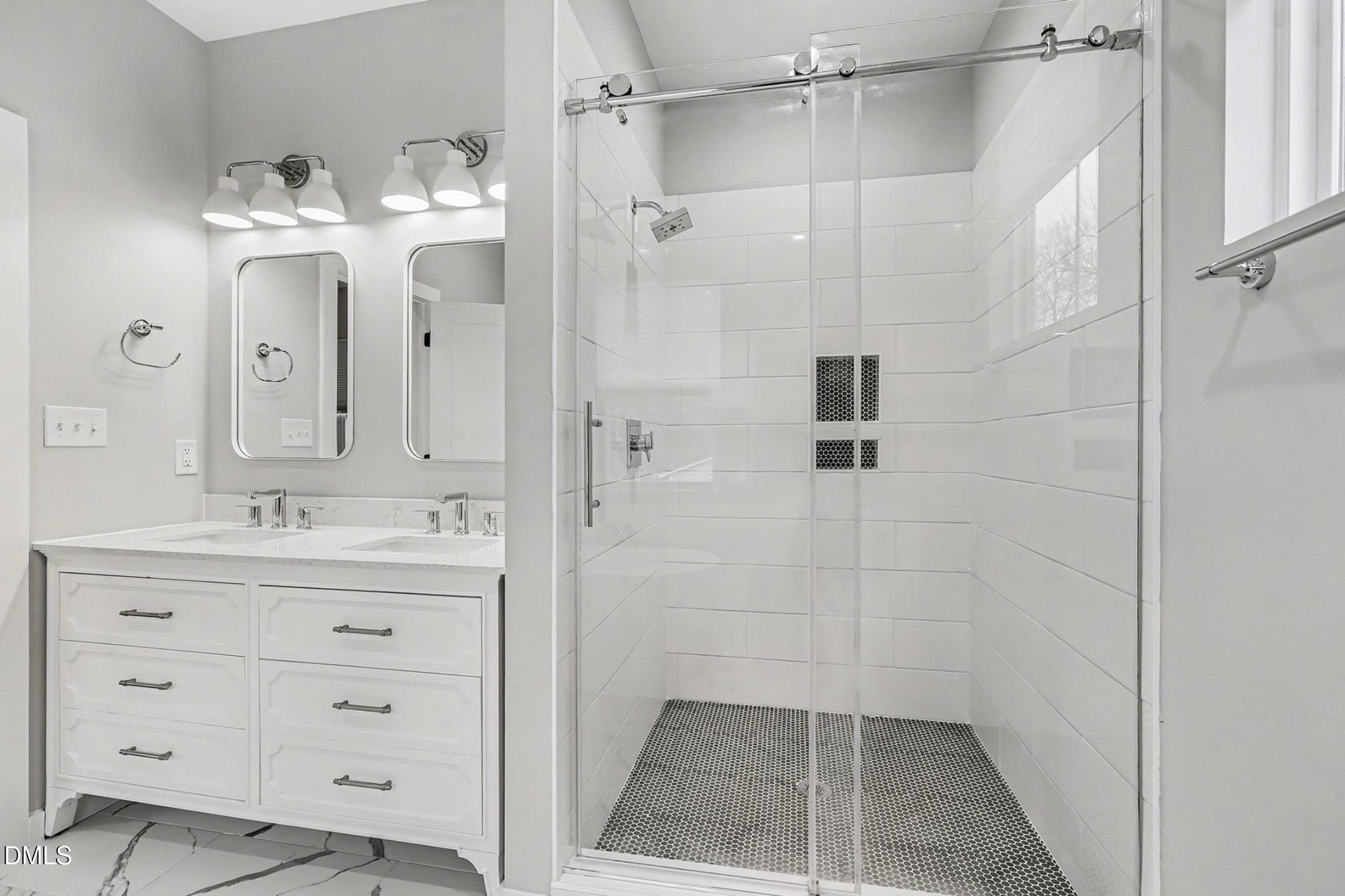 1508 East Jones Street Raleigh, NC 27610 - Photo 30 of 38 a bathroom with a double vanity sink mirror and shower