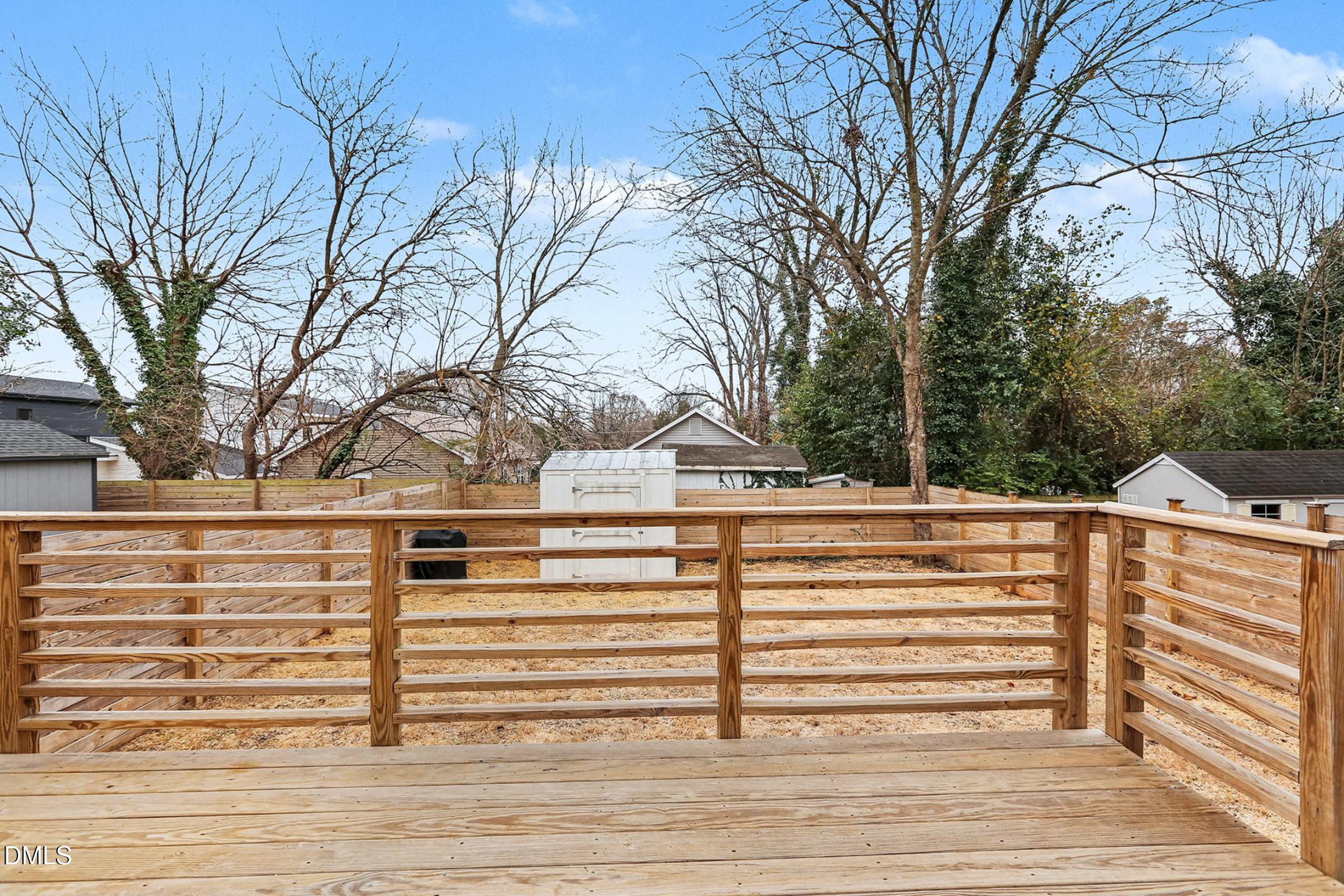 1508 East Jones Street Raleigh, NC 27610 - Photo 35 of 38 a view of a white house with a yard and wooden fence