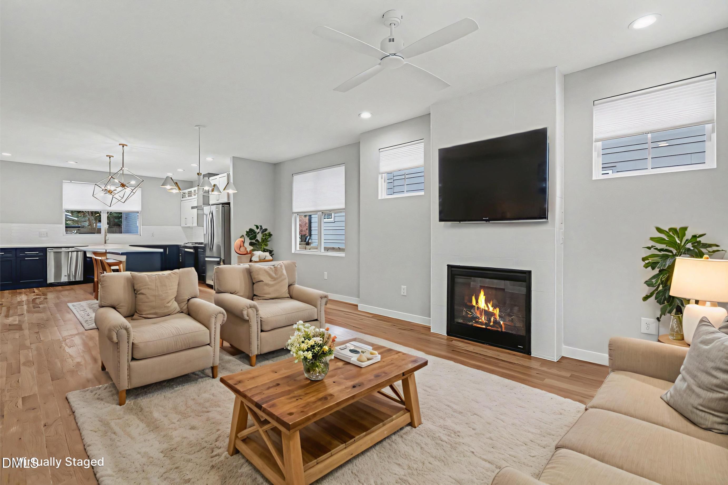 1508 East Jones Street Raleigh, NC 27610 - Photo 3 of 38 a living room with furniture a fireplace and a flat screen tv