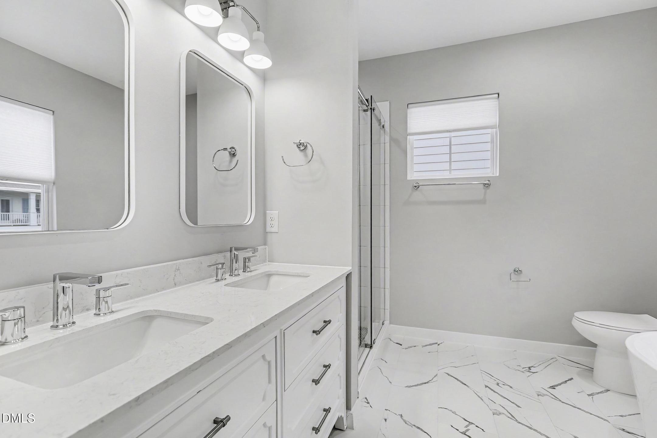 1508 East Jones Street Raleigh, NC 27610 - Photo 4 of 38 a bathroom with a sink a toilet and a mirror